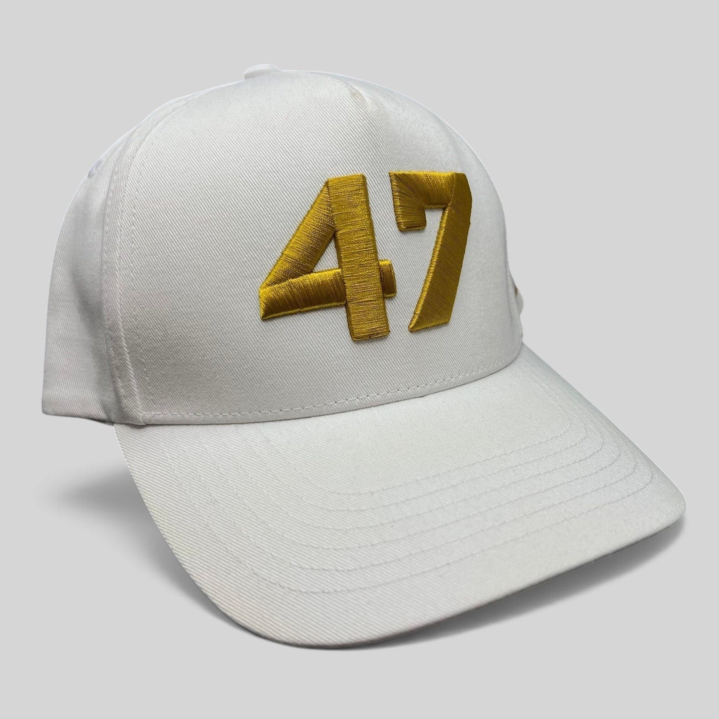 Raree Finds white cotton twill snapback hat with bold gold embroidered 47 on the front and a flat brim