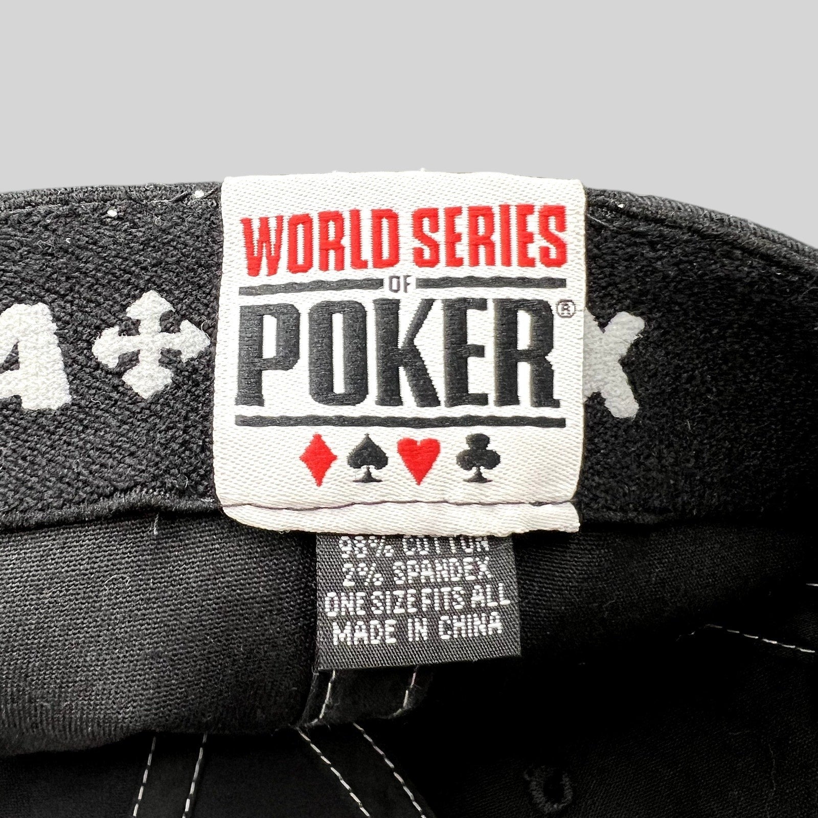 Raree Finds 2010 World Series of Poker hat interior tag showing brand logo, card suits, and material composition