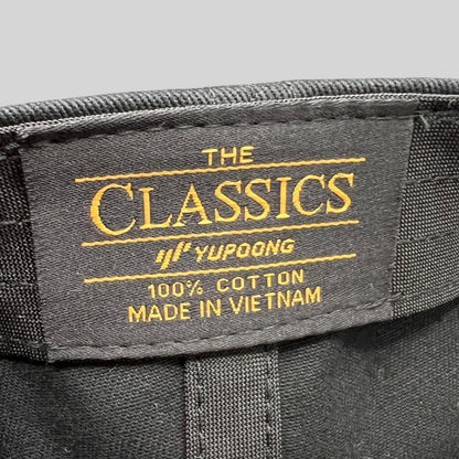 Raree Finds Yupoong The Classics black cotton hat interior label with gold embroidery