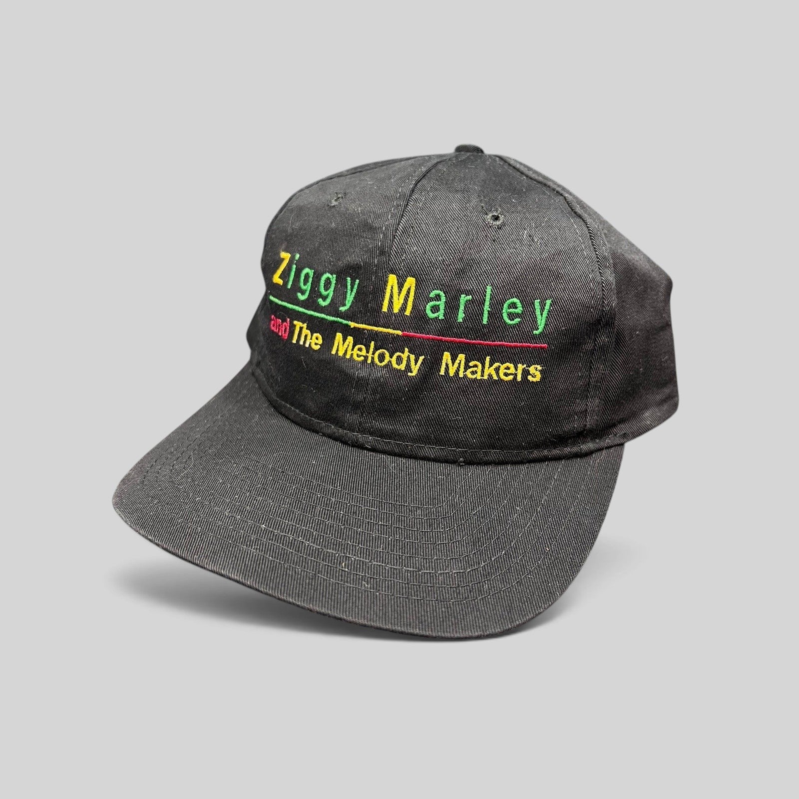 Raree Finds vintage 1995 Ziggy Marley and The Melody Makers black cotton snapback hat with Rasta-colored embroidery.